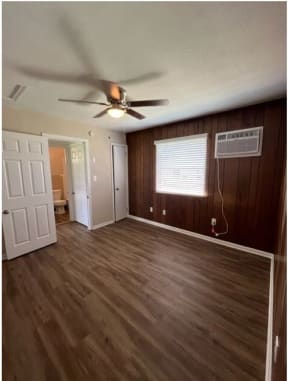 a living room with a ceiling fan and a window
