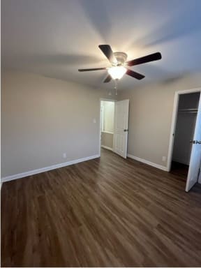 a living room with a ceiling fan and hardwood floors