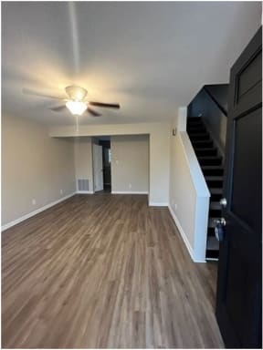 a living room with a ceiling fan and hardwood floors
