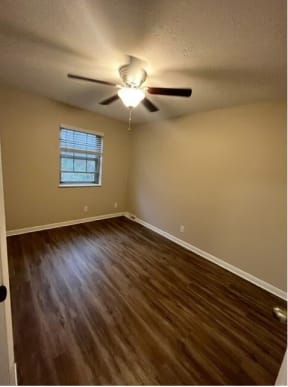 a room with a ceiling fan and a window