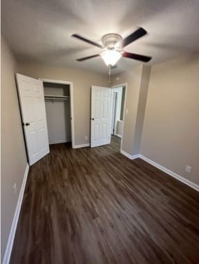 a room with a ceiling fan and a closet