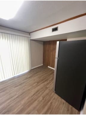an empty room with a refrigerator in it