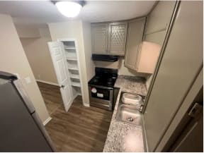 a kitchen with a stove a refrigerator and a sink