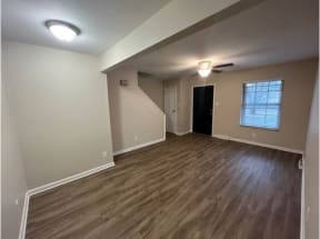 an empty room with a window and a door