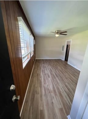 a room with a ceiling fan and a window