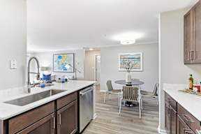 A kitchen with a table and chairs in the middle of the room.