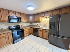 a kitchen with stainless steel appliances and wooden cabinets