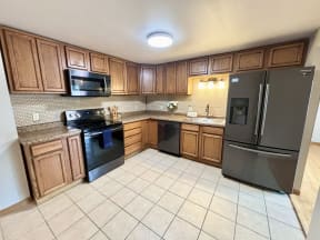a kitchen with stainless steel appliances and wooden cabinets