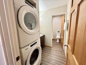 A laundry room with a washer and dryer stacked on top of each other.