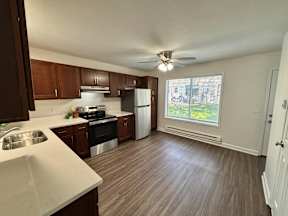A kitchen with brown cabinets and a white countertop.