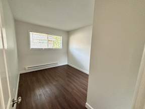 A room with a window and a door.