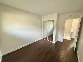 A room with wooden floors and white walls.