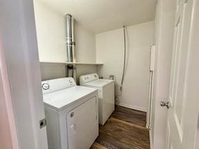 A small laundry room with a washer and dryer.