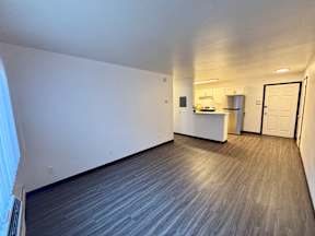 A room with a grey floor and white walls.