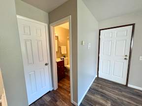 A white door is on the left and a brown door is on the right.