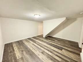A room with a wooden floor and a white ceiling.
