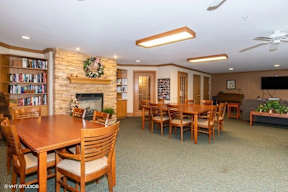 A room with a fireplace and a dining table.