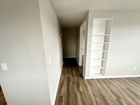 an empty room with wood flooring and a white closet
