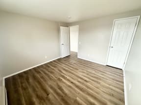 a living room with hard wood flooring and a door