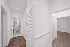 Hallway in 6128 Wilshire apartment home leading to bedrooms and bathroom