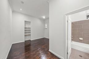 Additional bedroom in 6128 Wilshire Apartment home with high ceilings, wood flooring, private bathroom and closet space.