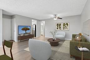 Oversized living area in Oro apartment home with wood-style plank flooring and a ceiling fan over dining nook.