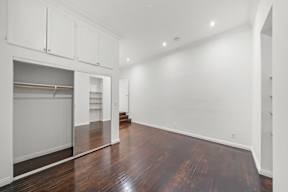 Beautiful bedroom in 6128 Wilshire apartment home with wood flooring, high ceilings, oversized closet, and private bathroom
