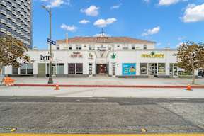 Streetview of 6128 Wilshire with commercial spaces out front, and unique retro LA architecture