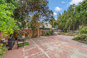 Exterior courtyard at 6128 Wilshire surrounded by trees and lush greenery