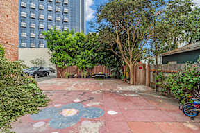Exterior courtyard at 6128 Wilshire surrounded by trees and lush greenery