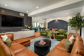 A living room with brown leather couches and a black coffee table.