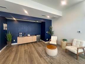 Leasing Office Interior at Oro with  coffee bar and seating area for prospects and residents to have an enjoyable and comfortable experience.