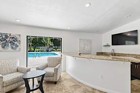 Seating area in community room with poolside views