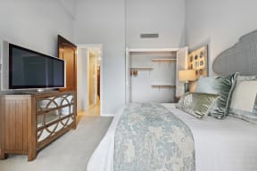 a bedroom with a large bed and a tv