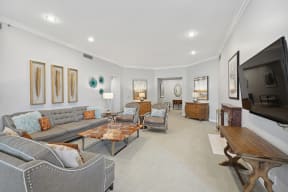 a living room with couches and chairs and a television