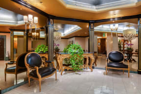 a lobby with chairs and a table in the middle