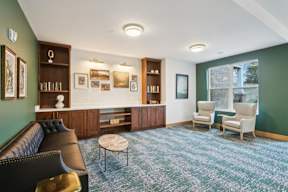A library with seating area located at Deforest Yards apartments in DeForest, WI