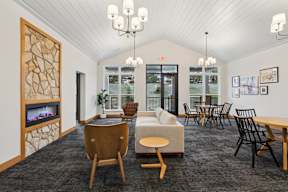 Lobby with a fireplace and a couch located at Deforest Yards apartments in DeForest, WI