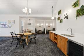 A kitchen with a table and chairs in the middle of the room.