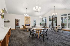 A dining room with a table set for six.