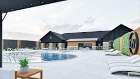 A pool area with a table and chairs with grilling outdoor area located at Deforest Yards apartments in DeForest, WI