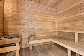 A wooden sauna with benches and a table located at Deforest Yards apartments in DeForest, WI