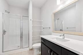 A white sink in a black and white bathroom located at Deforest Yards apartments in DeForest, WI