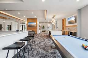 A club house with pool table, coffee bar and video game table located at Deforest Yards apartments in DeForest, WI