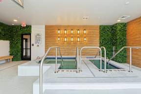 A pool with a green wall behind it.