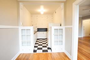 A black and white checkered floor in a kitchen.