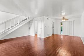 A room with wooden floors and white walls.