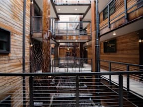 A wooden staircase with a metal railing.