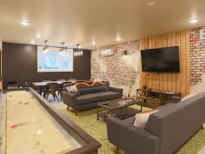 A room with a pool table and a couch.