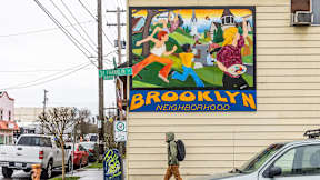 A mural on a building says Brooklyn Neighborhood.